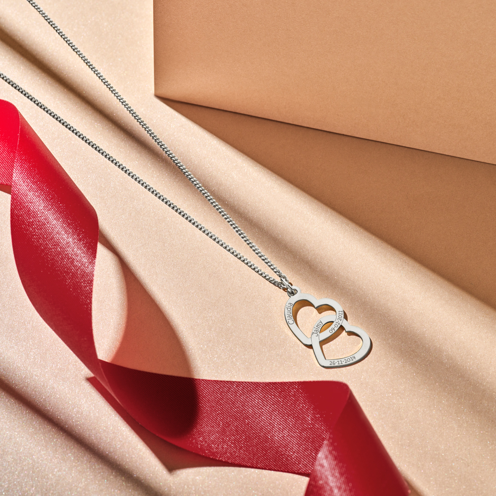 Sterling silver pendant with two linked hearts and engraving
